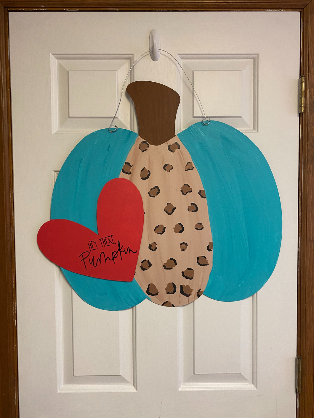 Large 24 inch bumpy pumpkin door hanger that is teal and leopard in color.